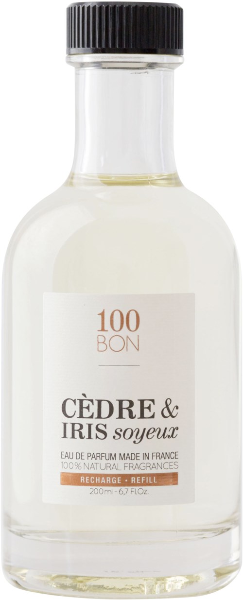 En klar glasflaska med svart lock, märkt som ceder och irisparfym, 200 ml, naturlig doft, på franska.