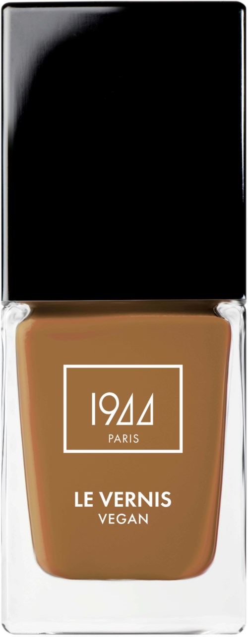 En flaska vegansnygellack i en genomskinlig låda, med svart lock och brunt lack, märkt '1944 PARIS LE VERNIS VEGAN'.