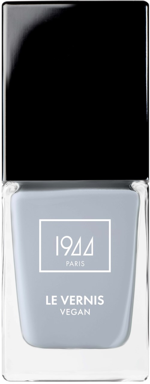 En vegansk nagellackflaska med svart lock och vit etikett, märkt '1944 Paris Le Vernis Vegan.'