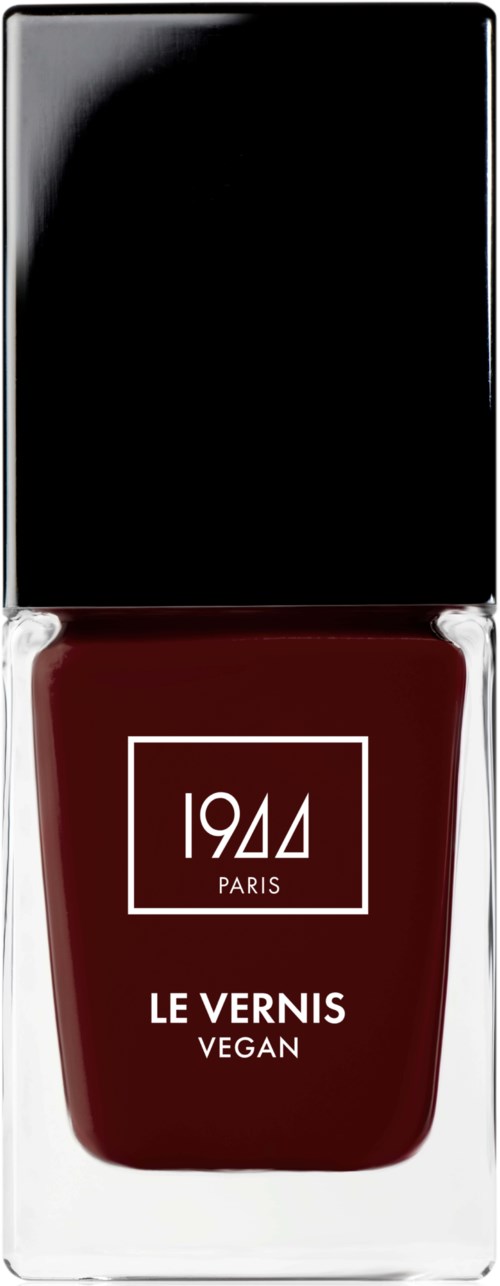 Veganskt nagellack i flaska med svart och röd design, märkt '1944 Paris' och 'Le Vernis Vegan.'