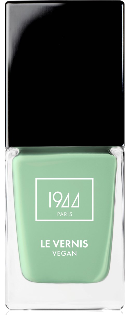 En grön nagellackflaska med svart lock, märkt '1944 PARIS LE VERNIS VEGAN.'