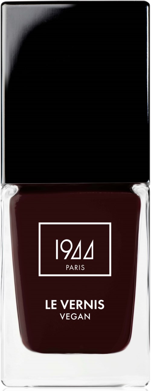 En mörkröd nagellackflaska med svart lock, märkt 1944, Paris, vegansk och Le Vernis-etikett.