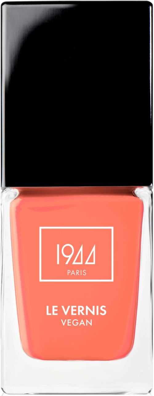 En korallfärgad vegansk nagellacksflaska med svart kork, med vit text och vit borderdesign.