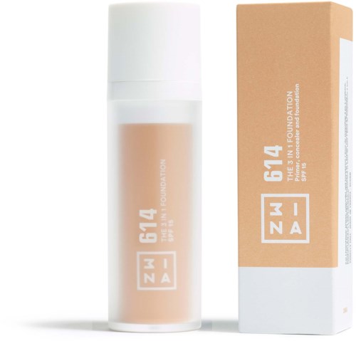 Beżowa butelka podkładu z białą nakrętką i opakowaniem, oznaczona 'ZMW 614 THE SKIN FOUNDATION SPF 15'.