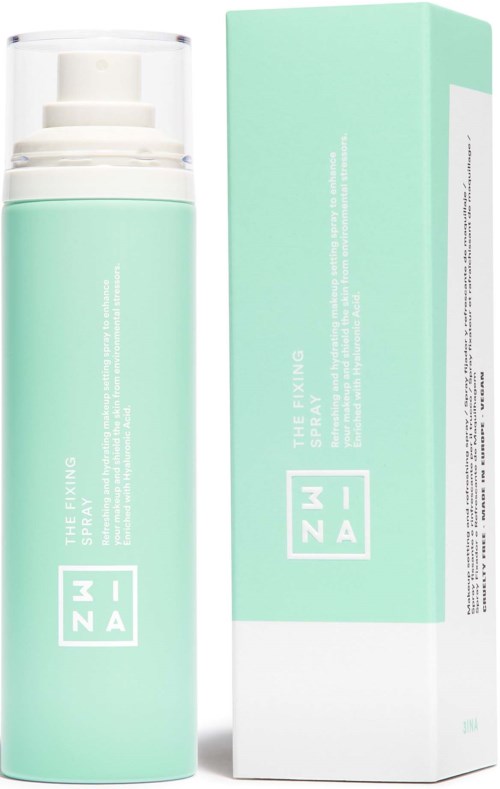 A mint green spray bottle labeled 'The Fixing Spray' next to its box, with simple white text.