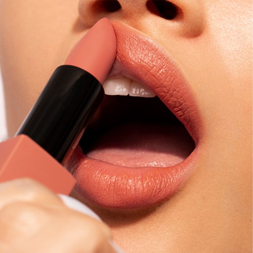 Close-up of lips being colored with lipstick, showing smooth, natural skin and slightly open mouth.