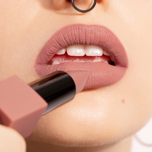 Close-up of lips being coated with light pink lipstick.