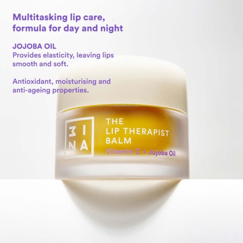 En beholder med læbepomade i gul og hvid emballage, der indeholder jojobaolie og vitamin C, designet til bløde, fugtgivende læber.