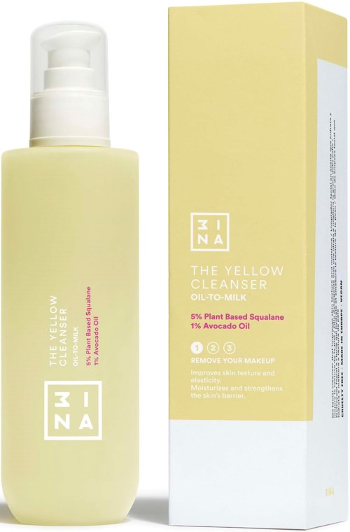 En lysegul flaske med pumpe, ved siden af sin matchende gule boks. Begge er til hudpleje, kaldet The Yellow Cleanser.
