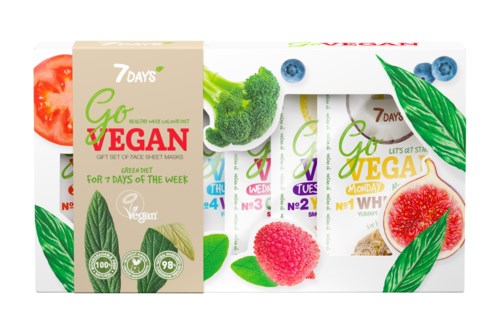 Ett box och paket av veganska ansiktsmasker omges av frukt och gröna blad.