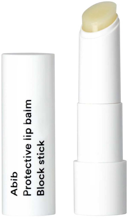 A white lip balm stick with a cap removed showing a pale yellow product inside.