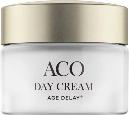 En burk med ACO Day Cream med guldfärgat lock, märkt som åldersfördröjning plus. Enkel och elegant design.