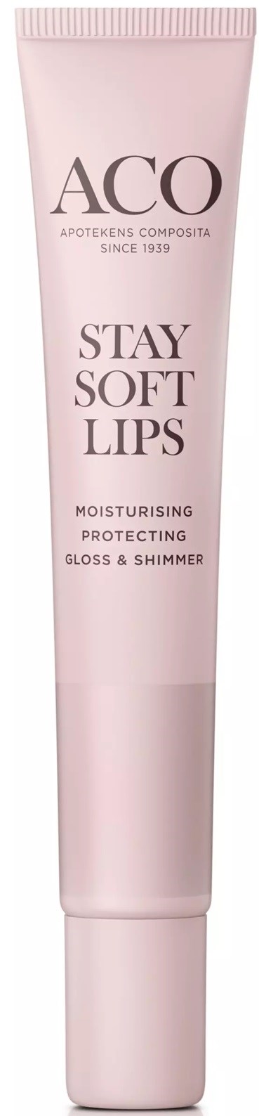 En rosa tub med läppbalsam eller läppglans märkt 'ACO Stay Soft Lips' med beskrivning 'Fuktgivande, Skyddande, Gloss & Shimmer.'