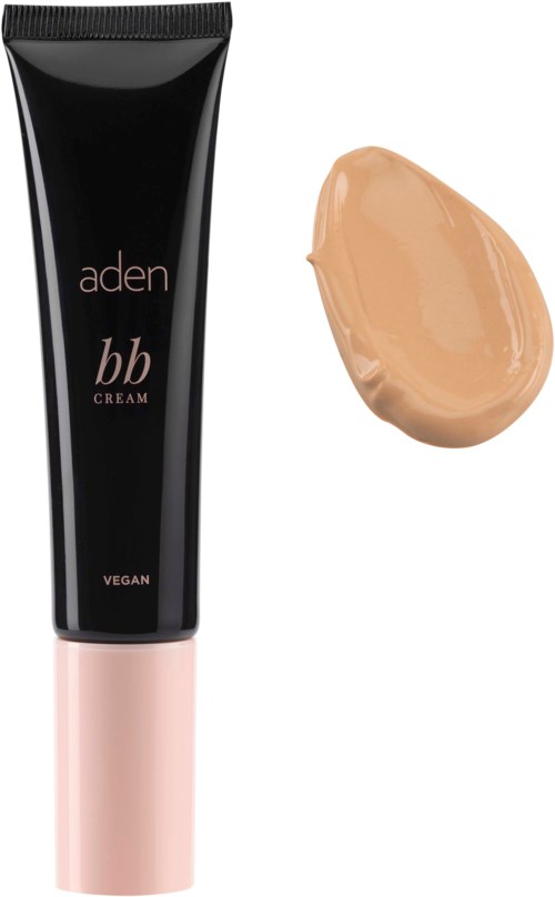En svart tube med vegansk BB-krem med rosa hette og en prøve av lys beige krem ved siden av.