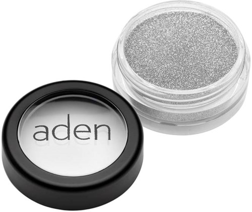 A small jar of silver glitter with a black lid that says "aden."