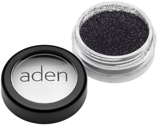 A small jar of black glitter with a black lid labeled "aden".