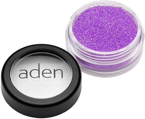 A small round container with purple glitter and a lid labeled "aden" placed beside it.