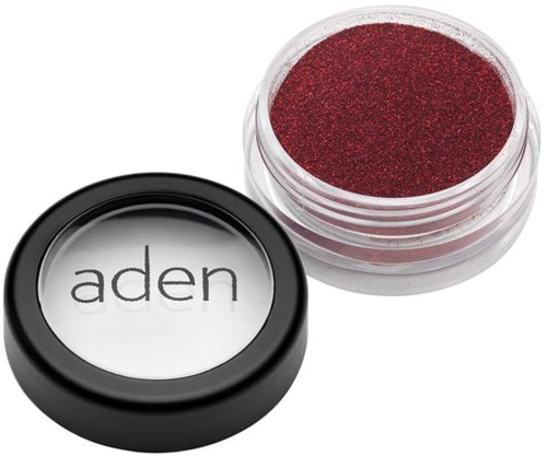 Red glitter eyeshadow in an open container, with a lid showing the brand 'aden'.