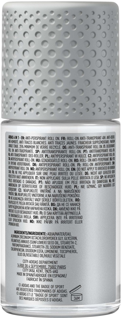 En vit sprayflaska med en texturerad, prickad kork och fransk text på etiketten som beskriver ingredienser och användning.