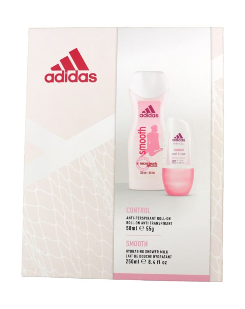 Adidas vårdset med rull-jon deodorant och duschmjölk, mest vitt med rosa accenter och rött märke.