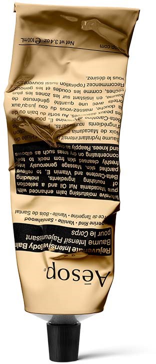 Tefteri, jossa on kultainen, musta ja beige väri, sisältäen hiustenmuotoilukreemiä Aesopilta.