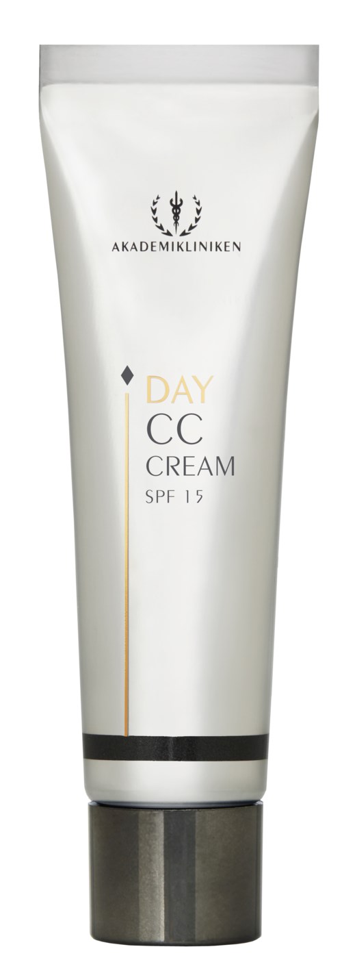 Vit tub med logga, text för en crème med SPF 15, och ett svart band nära locket.