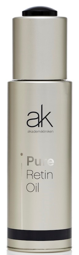 En hudvårdsoljekopp labeled 'Pure Retin Oil' av ak, med en enkel beige och svart design.