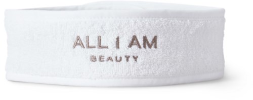 Vit runt skönhetsproduktförpackning med varumärkesnamn och tagline tryckt på den.
