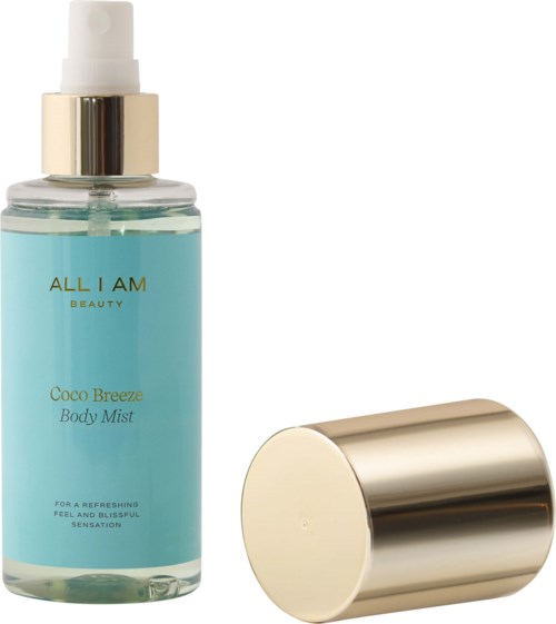 En blå kroppssprayflaska med guldkork och spraymunstycke, märkt 'Coco Breeze Body Mist'.
