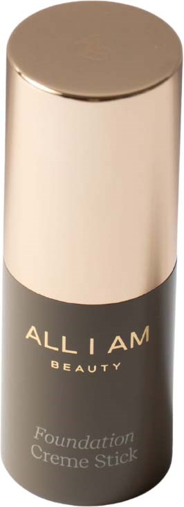 En flaska av Allium Beauty foundation stick, svart med ett guldlock, står upprätt.
