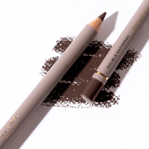 Brown pencil and a brown lipstick on white paper with brown smudges.