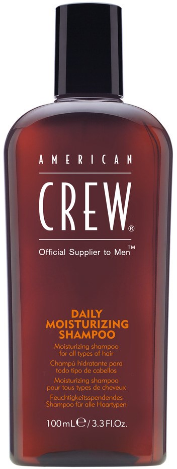 En mörkröd flaska med American Crew daglig återfuktande schampo och svart lock.
