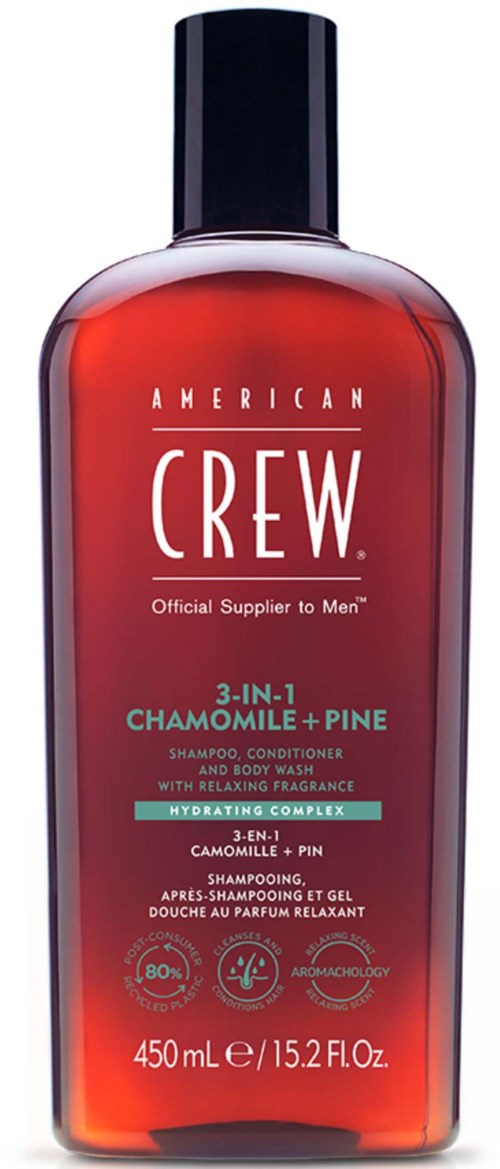 En röd flaska från American Crew 3-i-1 schampo, balsam och duschgel med svart lock och vit text.