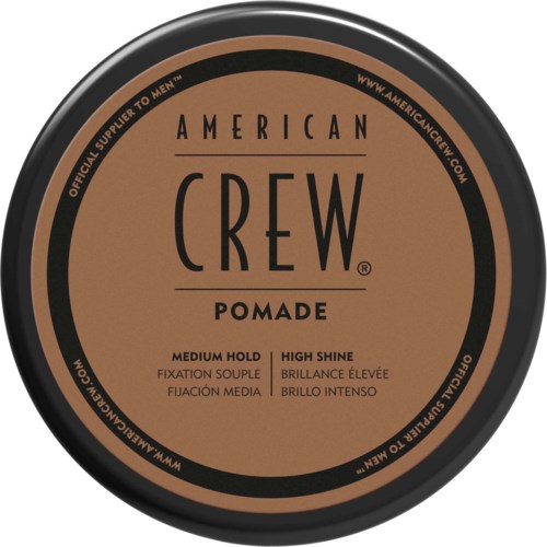 A round container label for American Crew Pomade with medium hold and high shine, in brown and black colors.