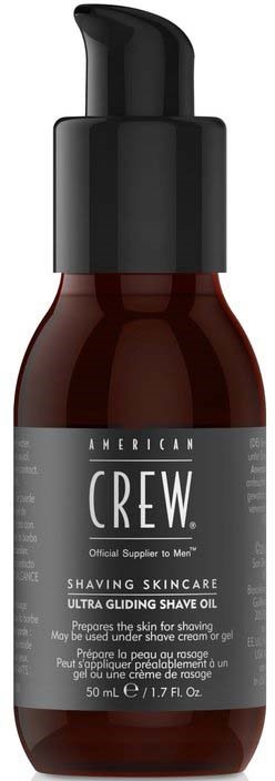 En brun flaska med svart pump, märkt som American Crew rakvårdsolja för män.