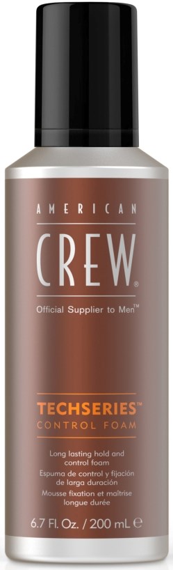 En flaska American Crew controlskum, med svart lock och silver- och orange etikett.