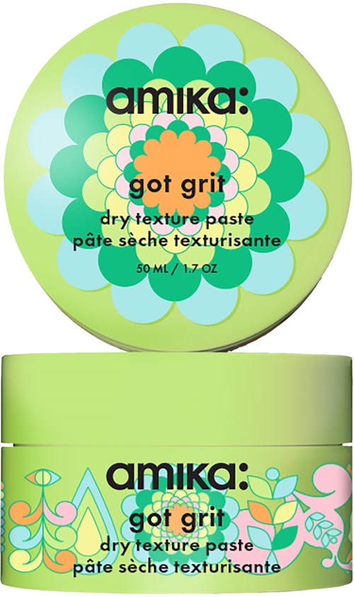 En rund behållare med grönt lock och färgglad blomsterdesign, märkt som torrtextur pasta kallad 'got grit'.