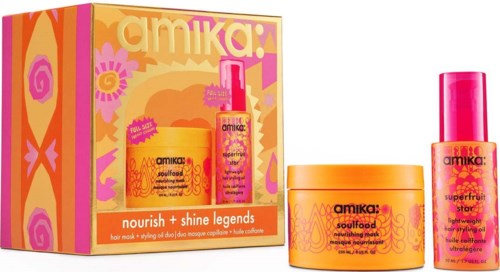Ein Set mit Amika Haarpflegeprodukten in orangefarbener und pinker Verpackung mit einer bunten Box.