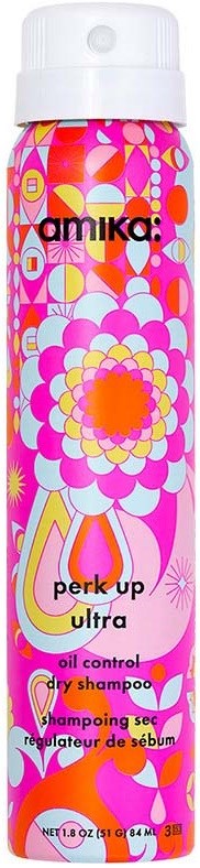 En lang flaske med fargerike blomster- og geometriske mønstre, merket som Amika Perk Up Ultra tørrsjampo.