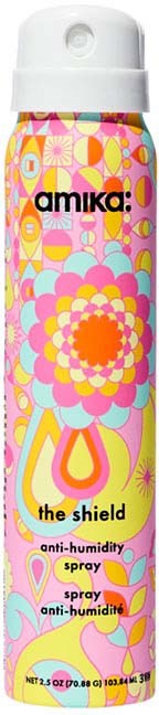 A colorful spray can with a floral design and the words "amika: the shield anti-humidity spray".