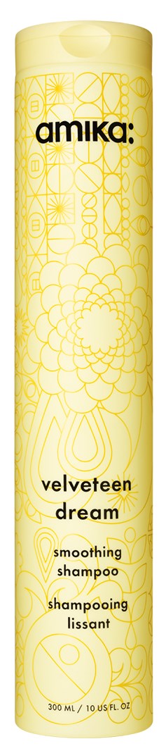 A tall, yellow can of Amika Velveten Dream smoothing shampoo with decorative patterns.