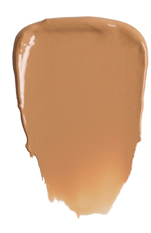 En beige-brun væskeprøve på hvit bakgrunn, glatt og skinnende, med ujevne kanter nederst.
