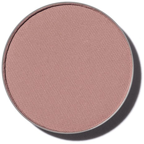 En rund rosa makeuprouge med matt yta och diskret texturerad yta.