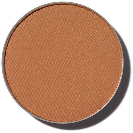 En rund makeup-rougeförpackning med ljusbrun nyans.