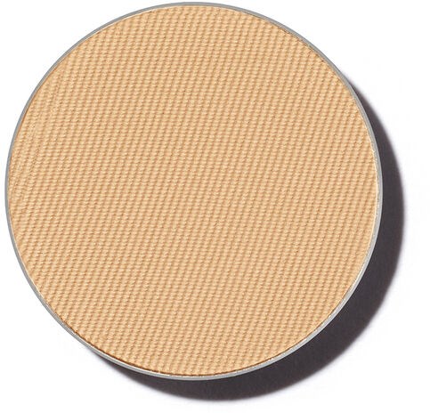 Det är ett runt sminkkompakt med beige pressad puder med en texturerad yta.