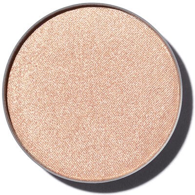En rund make-up-compact med skimrande, persikofärgad ögonskugga.