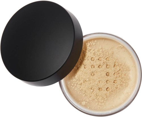 A round black container with a lid, filled with beige powder, possibly a cosmetic product.