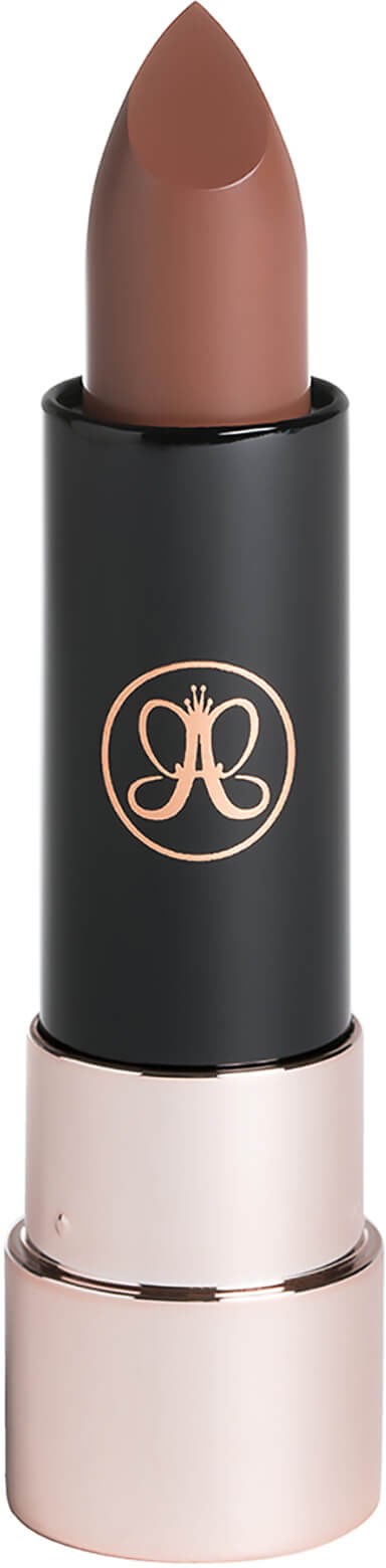 A brown lipstick in a black and gold tube with a logo on it.