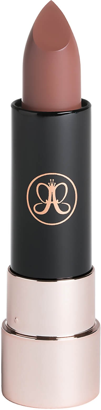 A lipstick with a black and pink casing, featuring a decorative logo, and a light nude color.