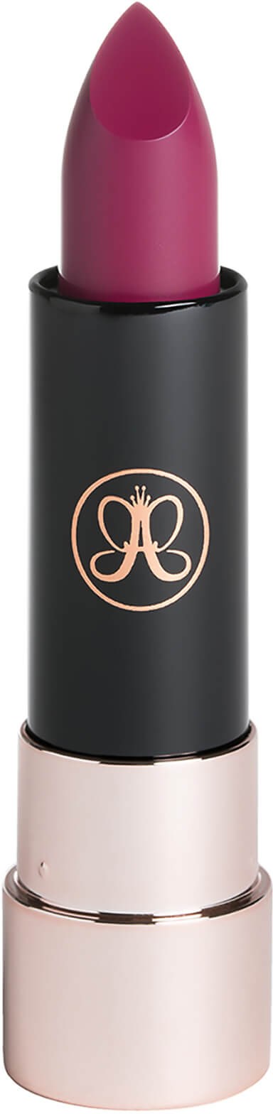 A pink lipstick in a black and gold tube with a logo on it.